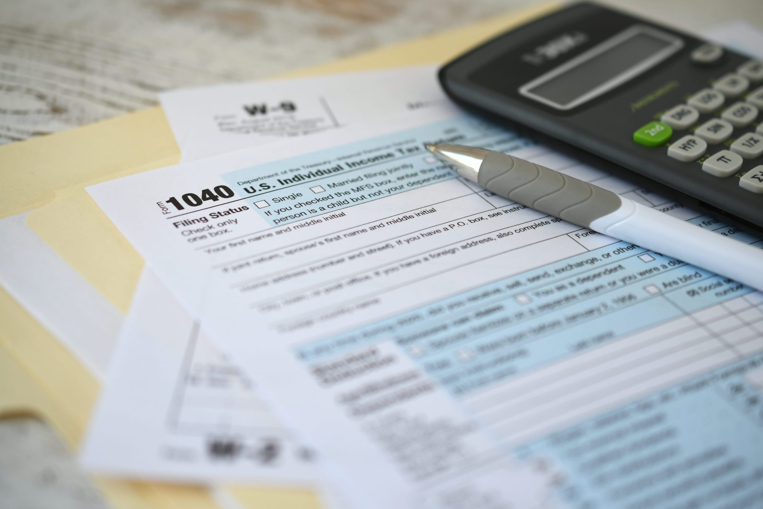 irs-1040-tax-return-form-with-ink-pen-and-calculat-2022-11-14-04-16-10-utc-min